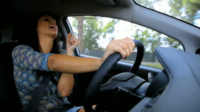 stock-footage-woman-singing-and-dancing-while-driving-car