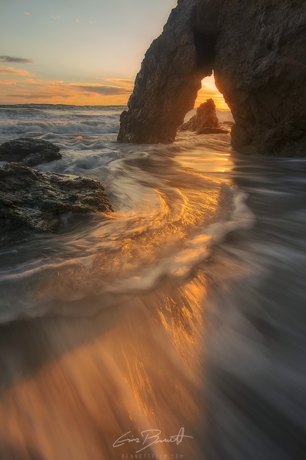 Sunset though a sea arch, El Matador, CA